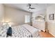 Cozy bedroom with light walls, featuring a white dresser with mirror, and a comfortable bed with decorative pillows at 2205 Sandstone Cliffs Dr, Henderson, NV 89044