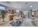 Bright dining area with modern lighting, bar seating, and open access to other living spaces at 2205 Sandstone Cliffs Dr, Henderson, NV 89044