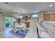 Open concept dining area with bar seating, adjacent to a modern kitchen and outdoor patio access at 2205 Sandstone Cliffs Dr, Henderson, NV 89044