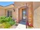 Beautiful front door with decorative ironwork and manicured landscaping at 2205 Sandstone Cliffs Dr, Henderson, NV 89044