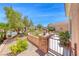 Gated courtyard with stone accents, mature landscaping, and walkway to the front door at 2205 Sandstone Cliffs Dr, Henderson, NV 89044