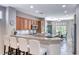 Well-lit kitchen with stainless steel appliances, granite countertops, and bar seating area at 2205 Sandstone Cliffs Dr, Henderson, NV 89044