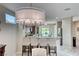 Modern kitchen bar with sleek bar stools and views into the kitchen with stainless appliances at 2205 Sandstone Cliffs Dr, Henderson, NV 89044