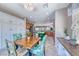 Bright, open kitchen with island, tile floors, and dining table featuring tropical-themed chairs at 2205 Sandstone Cliffs Dr, Henderson, NV 89044