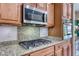 Close-up of the kitchen featuring stainless gas cooktop and granite counters at 2205 Sandstone Cliffs Dr, Henderson, NV 89044