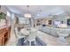 Open living area with tile floors, modern white furniture, and dining space at 2205 Sandstone Cliffs Dr, Henderson, NV 89044