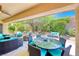 Inviting covered patio with comfortable seating and a dining area, perfect for outdoor entertaining at 2205 Sandstone Cliffs Dr, Henderson, NV 89044