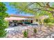 A gorgeous patio and outdoor kitchen offers a serene escape with ample seating and lush landscaping at 2205 Sandstone Cliffs Dr, Henderson, NV 89044