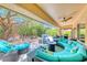 Expansive outdoor patio with comfortable seating, a fire pit, and beautifully landscaped surroundings at 2205 Sandstone Cliffs Dr, Henderson, NV 89044