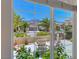 Backyard patio framed in a window showcases mountain views and desert landscaping at 2205 Sandstone Cliffs Dr, Henderson, NV 89044