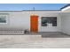 Exterior shot highlighting the home's bright orange front door and modern design elements at 2245 Sombrero Dr, Las Vegas, NV 89169