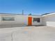 Bright, freshly painted home with orange front door with a well maintained yard and driveway at 2245 Sombrero Dr, Las Vegas, NV 89169