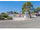 Street view of home showcasing the property's curb appeal with a big tree in the yard at 2245 Sombrero Dr, Las Vegas, NV 89169