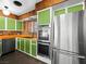 Well-designed kitchen featuring vibrant green cabinets, stainless steel appliances, and sleek countertops at 2245 Sombrero Dr, Las Vegas, NV 89169