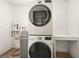 Modern laundry room with stacked washer and dryer and a tankless water heater at 2245 Sombrero Dr, Las Vegas, NV 89169