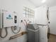 Modern laundry room featuring energy-efficient appliances and a convenient water heater system at 2245 Sombrero Dr, Las Vegas, NV 89169