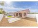 An inviting backyard showcases a covered patio, unique xeriscaping, synthetic grass, and privacy walls at 2403 Sexton Ave, North Las Vegas, NV 89031