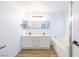 Bathroom with dual sinks, soaking tub, and modern fixtures at 2403 Sexton Ave, North Las Vegas, NV 89031