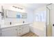 Bathroom with dual sinks, soaking tub, and modern fixtures at 2403 Sexton Ave, North Las Vegas, NV 89031