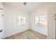 Bright bedroom featuring wood-look floors, natural light, and a built-in closet at 2403 Sexton Ave, North Las Vegas, NV 89031