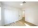 Bright bedroom with white walls, wood floors, and a closet with sliding doors at 2403 Sexton Ave, North Las Vegas, NV 89031