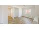 A bright bedroom with a window, ample wall space, and wood-look flooring at 2403 Sexton Ave, North Las Vegas, NV 89031