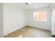 Cozy bedroom with wood-look floors and a window, featuring natural light at 2403 Sexton Ave, North Las Vegas, NV 89031