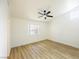 Neutral bedroom with wood flooring, large window, and ceiling fan at 2403 Sexton Ave, North Las Vegas, NV 89031