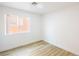 Neutral bedroom with a window letting in lots of light and modern wood-look floors at 2403 Sexton Ave, North Las Vegas, NV 89031
