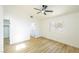 Bedroom with wood floors, ceiling fan, large window, and open door at 2403 Sexton Ave, North Las Vegas, NV 89031