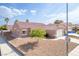 Charming single-story home with a well-maintained front yard, attached garage, and neutral-colored exterior at 2403 Sexton Ave, North Las Vegas, NV 89031