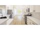 Modern kitchen with stainless steel appliances, white cabinets, and a light countertop on wood-look flooring at 2403 Sexton Ave, North Las Vegas, NV 89031