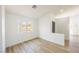 Sunlit living room features wood-look floors and a large window with street views at 2403 Sexton Ave, North Las Vegas, NV 89031