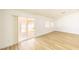 Bright living room with wood-look flooring and sliding glass doors leading to the backyard at 2403 Sexton Ave, North Las Vegas, NV 89031