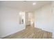Bright living room with white walls and wood-look flooring at 2403 Sexton Ave, North Las Vegas, NV 89031