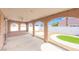 A covered patio features arched openings, seating and a view of the beautifully xeriscaped backyard at 2403 Sexton Ave, North Las Vegas, NV 89031