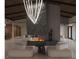Expansive living room with central fireplace and modern lighting at 2935 Montessouri St, Las Vegas, NV 89117