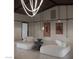 Comfortable living room with soft-looking furniture and modern lighting fixture at 2935 Montessouri St, Las Vegas, NV 89117