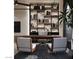 Stylish office space featuring a stone accent wall with shelving, modern lighting, and ergonomic seating at 2935 Montessouri St, Las Vegas, NV 89117