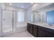 Bright bathroom with double vanity, soaking tub, and glass shower at 31 Newport Edge Pl, Henderson, NV 89015