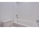 Clean bathroom featuring a shower-tub combo with white tiled walls and toilet at 31 Newport Edge Pl, Henderson, NV 89015