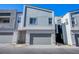 Modern townhome exterior featuring a garage and neutral color scheme at 31 Newport Edge Pl, Henderson, NV 89015