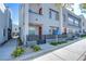 Modern two-story townhome featuring a balcony, fenced yard, and contemporary architectural details at 31 Newport Edge Pl, Henderson, NV 89015