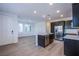 Spacious open concept kitchen with dark cabinets, stainless appliances, and light countertops at 31 Newport Edge Pl, Henderson, NV 89015