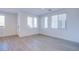 Bright and spacious living room featuring light wood flooring and ample natural light at 31 Newport Edge Pl, Henderson, NV 89015
