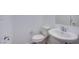 Modern powder room featuring a toilet and pedestal sink with stylish chrome fixtures at 31 Newport Edge Pl, Henderson, NV 89015