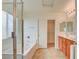 Bright bathroom featuring double sinks, tile flooring, a tub, and a glass-enclosed shower at 3429 Glacial Lake St, Las Vegas, NV 89122