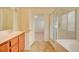 Bright bathroom featuring double vanity, tile floor, and separate glass enclosed shower and tub at 3429 Glacial Lake St, Las Vegas, NV 89122