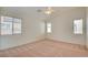 Spacious bedroom with neutral carpet, ceiling fan, and multiple windows at 3429 Glacial Lake St, Las Vegas, NV 89122