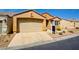 Tan single-story home with desert landscaping, a two-car garage and front entrance at 3429 Glacial Lake St, Las Vegas, NV 89122